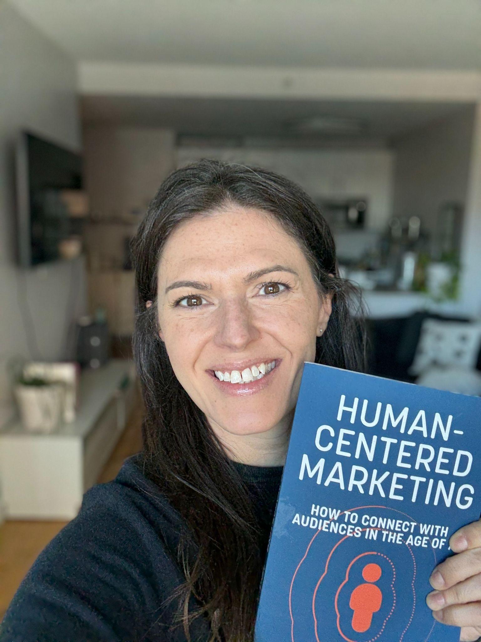 Devin Bramhall holding Human-Centered marketing book